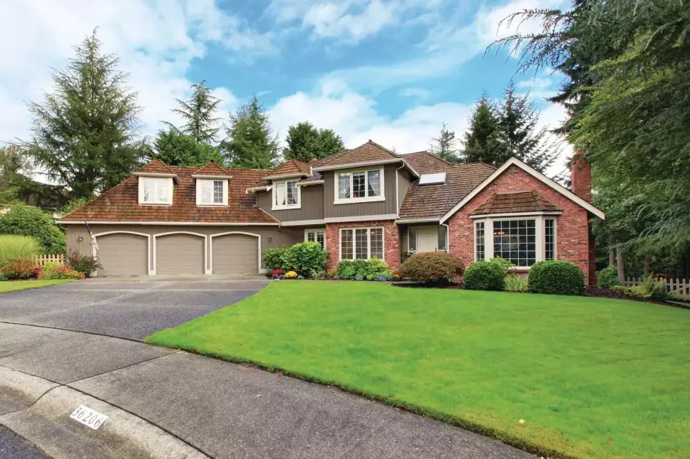 Two-story suburban home viewed from the sidewalk.